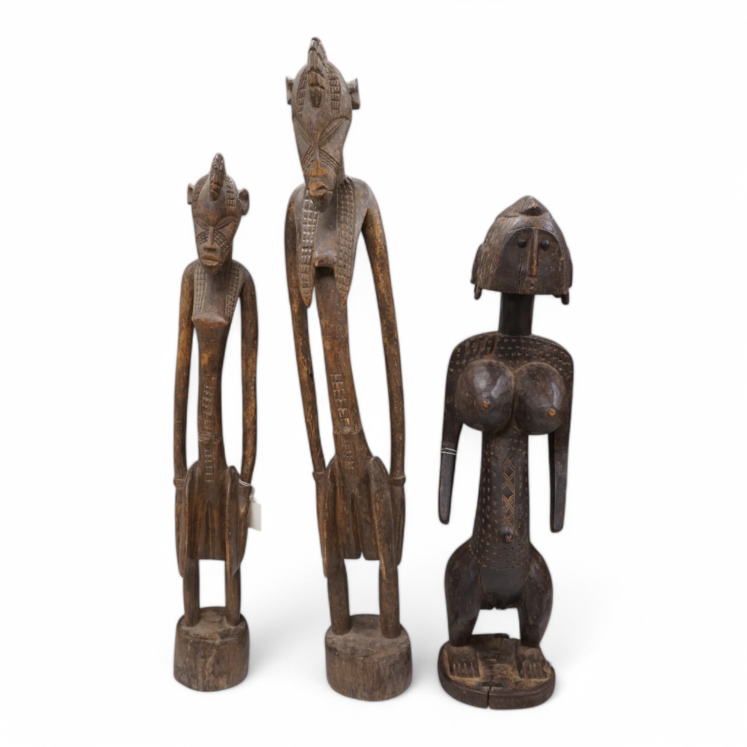 Three African tribal figural carvings including one Dogon maternity figure, largest 82cm. Condition - some cracking